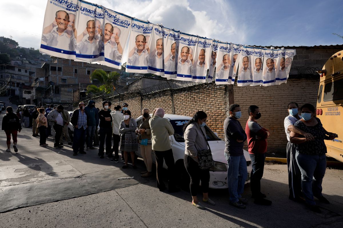 Voters line up outside a polling station during general elections in Tegucigalpa, Honduras, Sunday, Nov. 28, 2021.  (Moises Castillo)