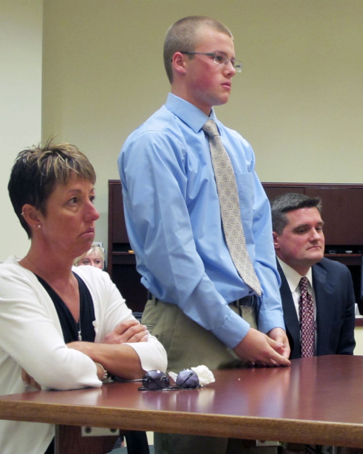 Tyler Pagenstecher, 18, center, listens in juvenile court, Monday, Oct. 22, 2012, in Lebanon, Ohio, as a judge sentences him to a minimum of six months in a juvenile jail stemming from his conviction on drug-trafficking charges. Pagenstecher is flanked by his mother, 50-year-old Daffney Pagenstecher, and his attorney, Mike O