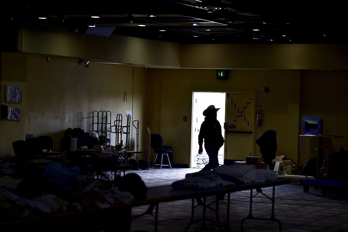 Volunteer Randall Totus walks through a room of donations for fire victims Thursday at the Okanogan Bingo Casino near Okanogan, Wash. (Tyler Tjomsland)