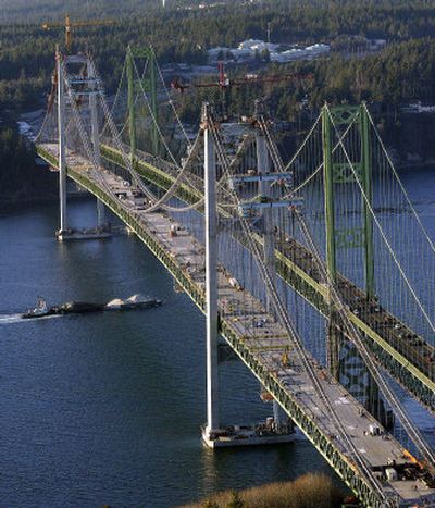 
Two bridges span the Tacoma Narrows with the lifting and placement of the final bridge deck section of the new Tacoma Narrows bridge, left, on Jan. 30. 
 (File Associated Press / The Spokesman-Review)