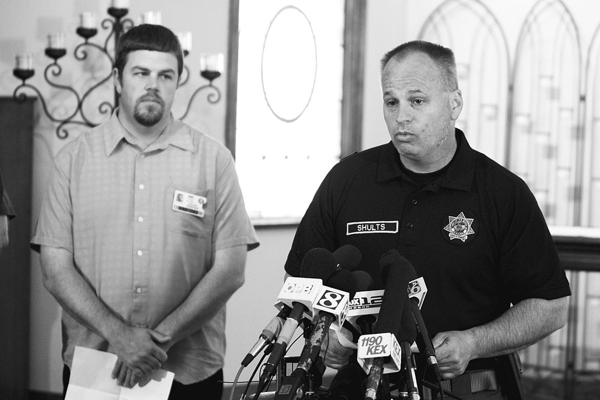 Watched by school principal Ben Keefer, left, Capt. Mike Shults of the Multnomah County Sheriff