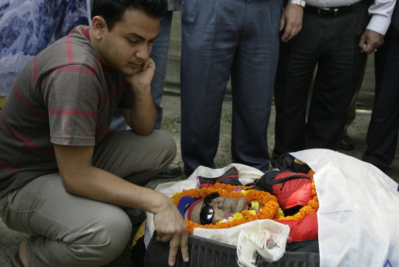 Bidhur Kumar Upadhyay grieves near the body of his grandfather, 82-year-old former Nepalese Foreign Minister Shailendra Kumar Upadhyay, who died on the slopes of Mount Everest while attempting to become the oldest person to climb the world's highest mountain, in Katmandu, Nepal, Wednesday, May 11, 2011.  (Associated Press)