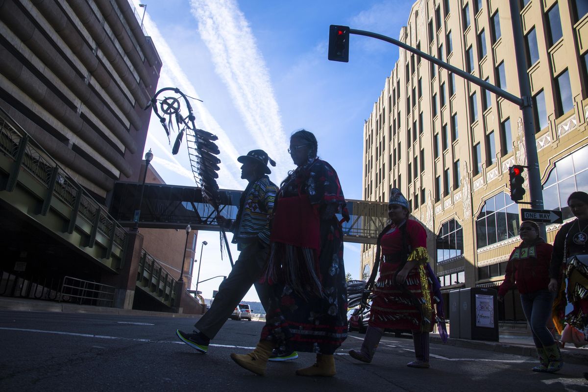 David BrownEagle, Spokane Tribal Council Vice-Chair, leads a group of marchers across Spokane Falls Boulevard during the Indigenous People’s Celebration, Monday, Oct. 9, 2017. (Dan Pelle / The Spokesman-Review)