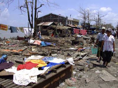 
Myanmar residents walk past houses destroyed by Cyclone Nargis in Bogalay on Friday. Associated Press
 (Associated Press / The Spokesman-Review)