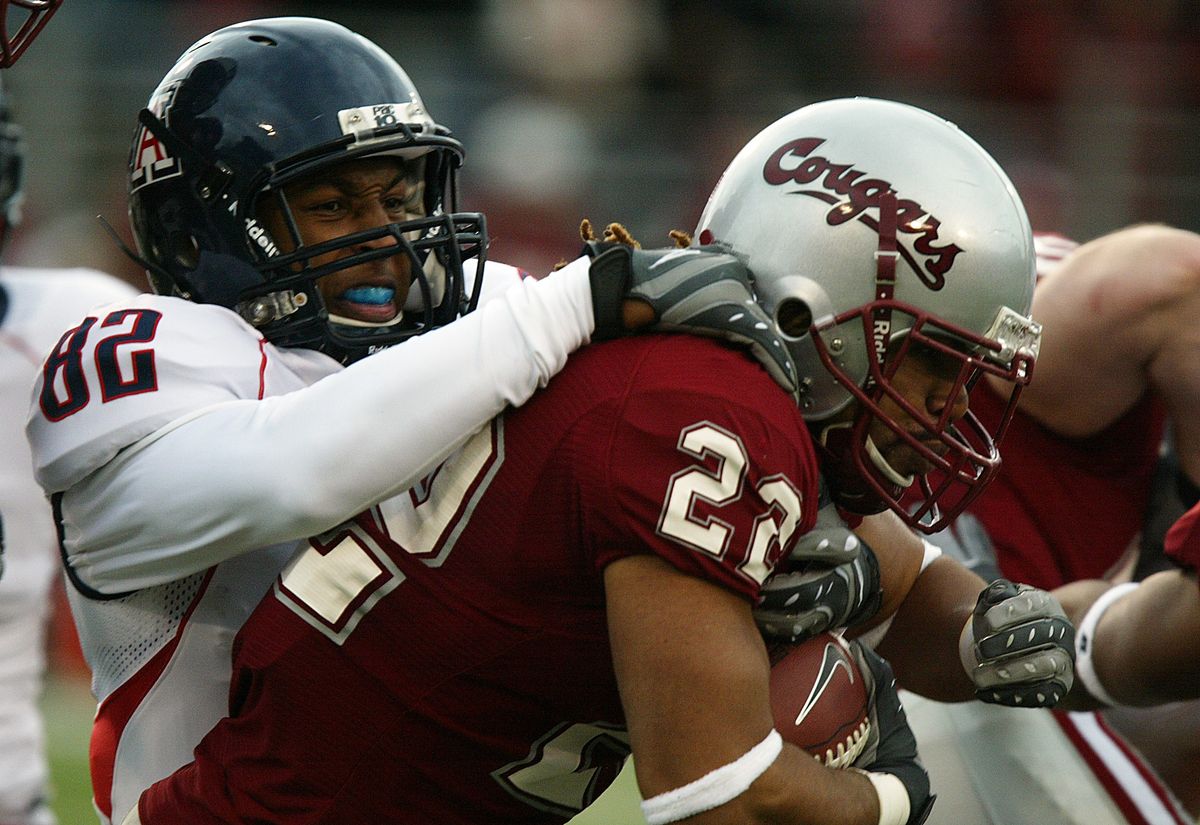 Arizona’s Juron Criner tackles Washington State’s Chantz Staden on a kick return in the first quarter.  (Associated Press / The Spokesman-Review)