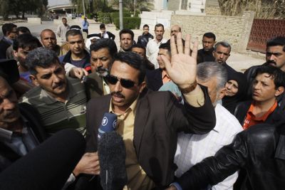 Odei al-Zeidi, center, brother of Iraqi journalist Muntadhar al-Zeidi, who gained cult status for throwing his shoes at President George W. Bush last year, talks to media outside court Thursday as his brother was brought to a hearing in Baghdad.  (Associated Press / The Spokesman-Review)