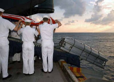 
In this photo released by the Pentagon in response to a Freedom of Information Act request, the casket bearing the body of U.S. Navy Machinist's Mate Third Class Nathan Taylor goes over the edge of the aircraft carrier USS Enterprise as Navy sailors conduct a Burial at Sea ceremony on May 19, 2004. 
 (Associated Press / The Spokesman-Review)