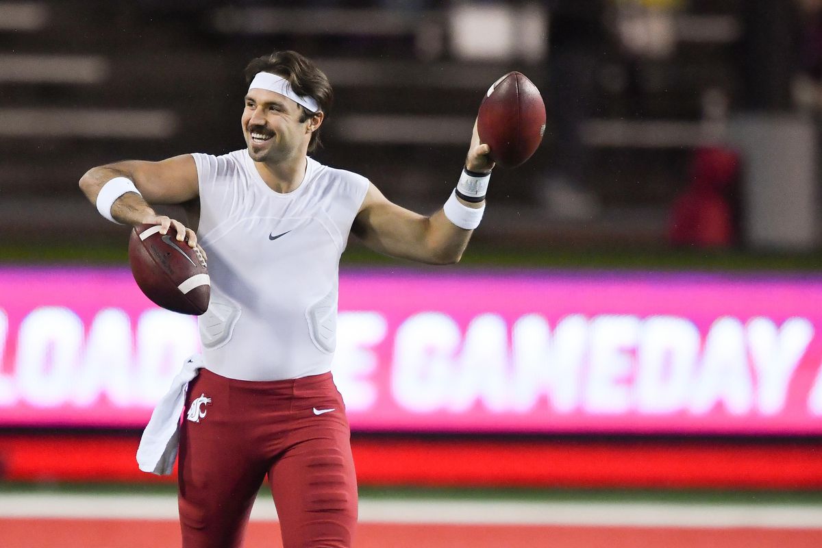 Washington State  quarterback Gardner Minshew  smiles to a cheering  fan section as he warms up before  Friday’s Apple Cup  in Pullman. (Tyler Tjomsland / The Spokesman-Review)