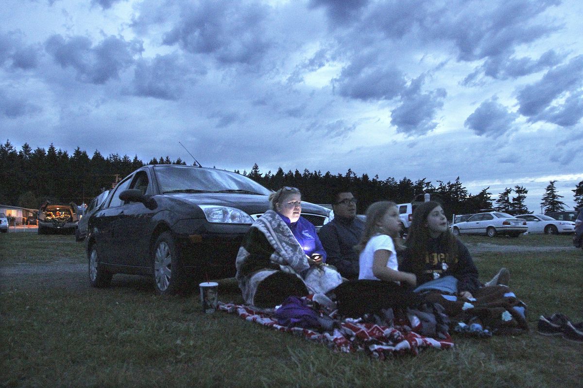 From left, Anne Barnett, Michael Reyna, Megan Henning and Bronte Lacey watch a screening of “Madagascar 3” at the Blue Fox Drive-In Theater in Oak Harbor, Wash., on June 26. (John Lok)