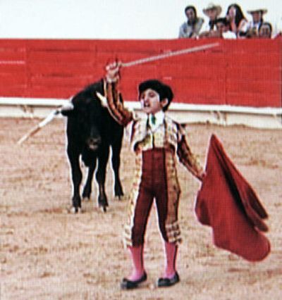 
In this image from television, 9-year-old Rafita Maribal holds up his sword, turning his back on a 2-year-old cow with horns. 
 (Associated Press / The Spokesman-Review)