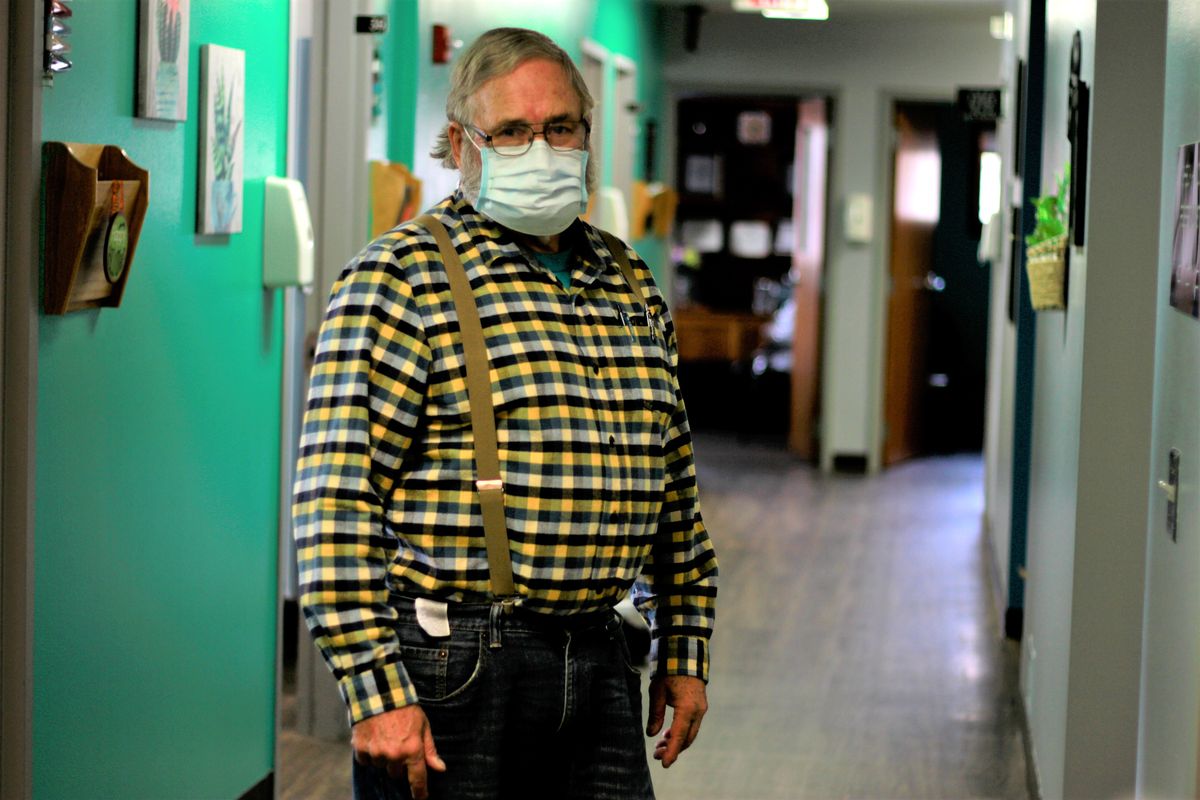 Dr. Tom Dean poses at his clinic in Wessington Springs, S.D., on Friday. Dean writes a column in the local newspaper, the True Dakotan, urging people to take precautions against the virus.  (Stephen Groves)