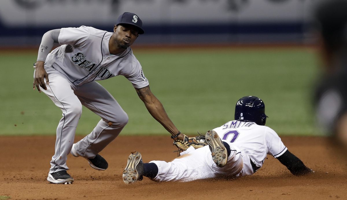 Seattle Mariners second baseman Dee Gordon, left, tags out Tampa Bay Rays