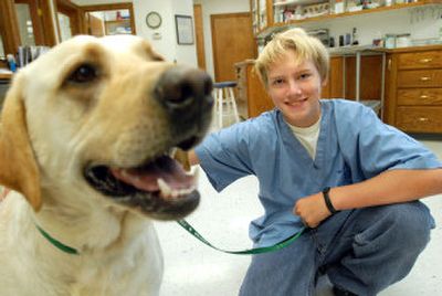 
Wyatt Armstrong, 15, poses with his dog Zeus at Hayden Pet Medical Center  where he volunteers. 
 (Jesse Tinsley / The Spokesman-Review)