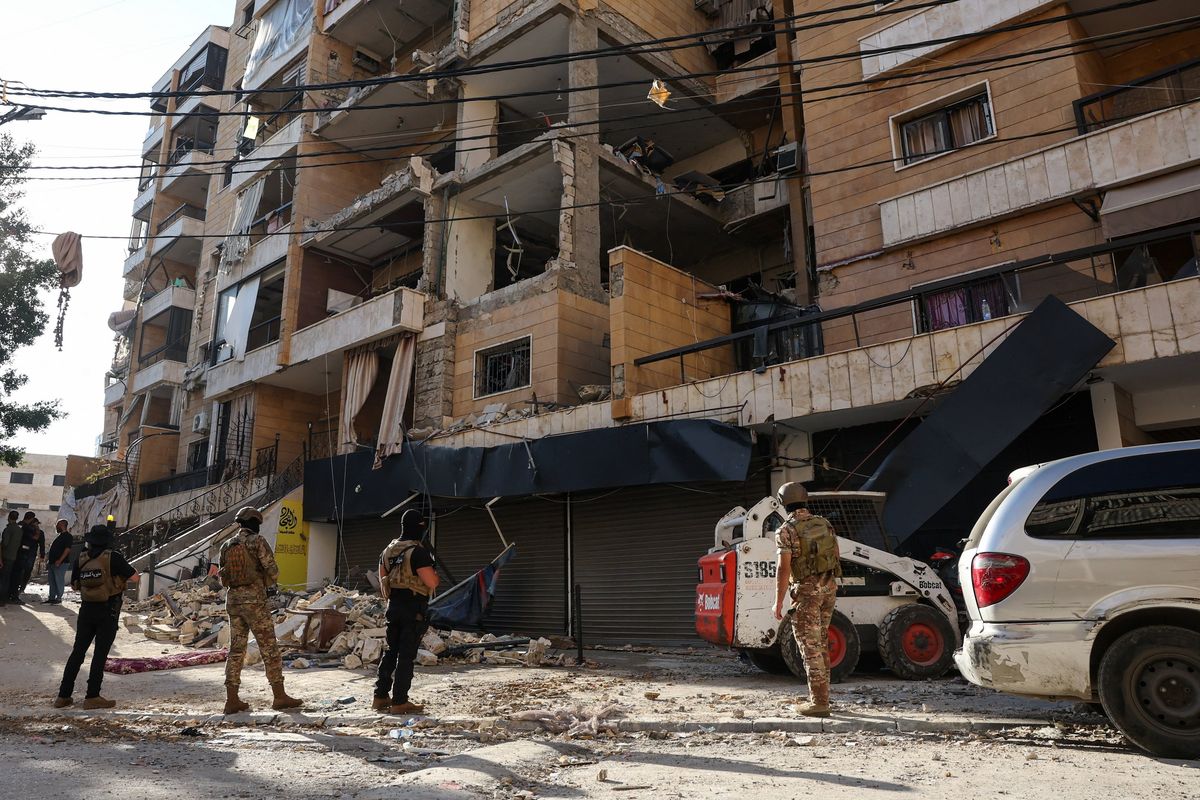 Emergency personnel work Sunday at the site of an Israeli strike on the southern suburbs of Beirut.  (Reuters )