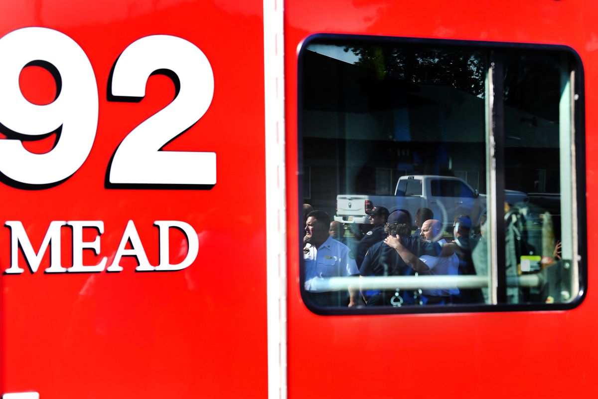 Fire Fighters gather and embrace following a press conference on Monday, Jun 21, 2021, at Spokane County Fire District 9 in Mead, Wash after Lt. Cody Traber was killed in the line of duty at on Thursday, Aug. 26 while answering a fire call in north Spokane, near Highway 395 and Wandermere Road.  (Tyler Tjomsland/The Spokesman-Review)