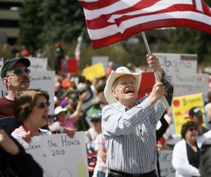 Roger Warrick, 71, from Boise, waves his flag on the state capitol steps in downtown Boise, Idaho during a Tea Party Boise tax day rally on Thursday, April 15, 2010. "I'm really worried about the way this country is headed," said Warrick. " I see this country moving further and further to the left, in fact, I almost think it's moving toward communism. And I look at my grandchildren in which I have 23 and I see the debt that's piling up under this administration and I just feel so bad for my children and grandchildren. We need to get involved and change this and we need to get back to the conservative principles that built this country." (Shawn Raaecke / The Idaho Statesman)
