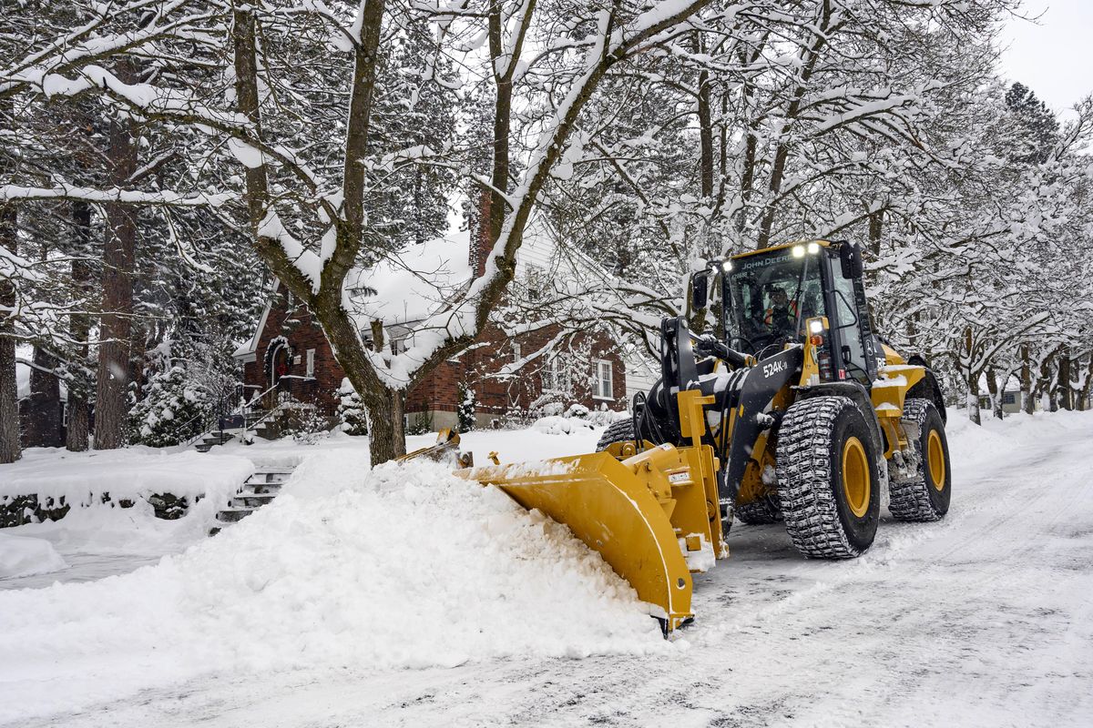 A city plow clears snow from Monroe Street at 22nd Avenue on Tuesday, Feb 12, 2019 in Spokane. (Colin Mulvany / The Spokesman-Review)