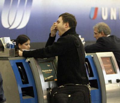 
Passengers check in at the United Airlines counter Wednesday at Chicago O'Hare International Airport. UAL Corp.'s United Airlines and Continental Airlines Inc. are exploring a possible merger. 
 (Associated Press / The Spokesman-Review)