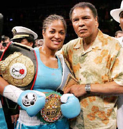 
Laila Ali poses with her father, boxing great Muhammad Ali, after her win against Erin Toughill.
 (Associated Press / The Spokesman-Review)
