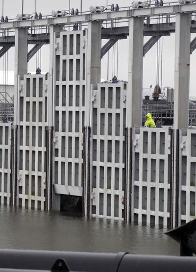 The final three floodgates are lowered into position at the London Avenue outflow canal Friday in New Orleans. (Associated Press)