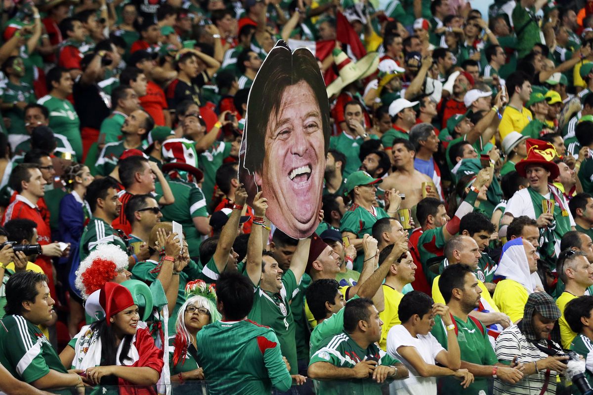 It’s easy to see that Mexico’s Miguel Herrera is called the people’s coach. (Associated Press)