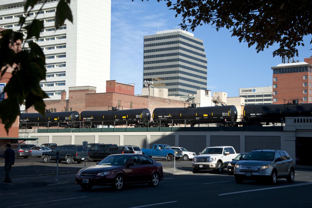 In this Oct. 1, 2014 file photo, train cars carrying flammable liquids heads west through downtown Spokane. (Dan Pelle / The Spokesman-Review)