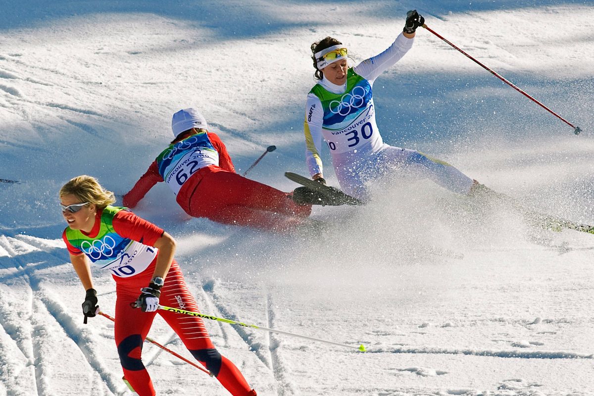 Vibeke Skofterud, left, escapes a crash involving Norgren Johansson, right, and Paulina Maciuszek in a cross country skiing event in Whistler, B.C., in 2010.  (Andrew Vaughan)