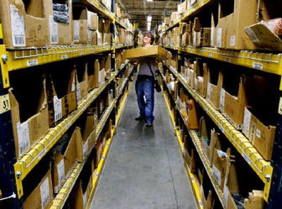 
Justin Varberakis restocks shelves at the L.L. Bean warehouse in Freeport, Maine, last week. The store is offering free shipping for the first time in three years to all of its customers as it tries to get an early jump on a holiday season in which high gas prices and heating costs could influence consumer spending. 
 (Associated Press / The Spokesman-Review)
