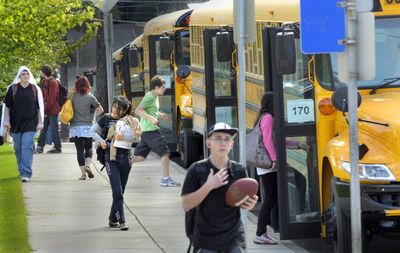 Students board Durham School Services buses outside Lewis and Clark High School on Friday in Spokane. This is Durham’s first year providing bus service for Spokane Public Schools. The company said route problems had been addressed by Friday.  (CHRISTOPHER ANDERSON / The Spokesman-Review)
