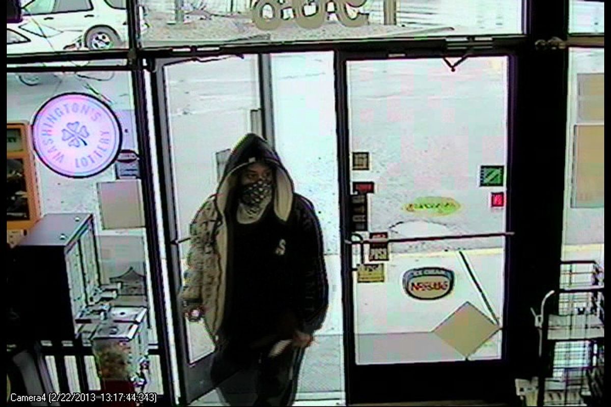 Spokane Police released this photograph of a man suspected of robbing Sunset Highway Grocery at knife-point on Friday, Feb. 22. The suspect is described as a light-skinned black or Hispanic man wearing a distinctive black and white coat with the letters “L A” on the back. (Spokane Police Department)