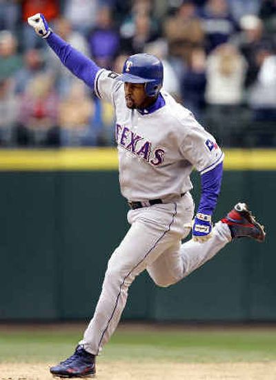 
Texas Rangers' Richard Hildalgo raises his fist as he rounds the bases on his two-run, ninth-inning home run. 
 (Associated Press / The Spokesman-Review)