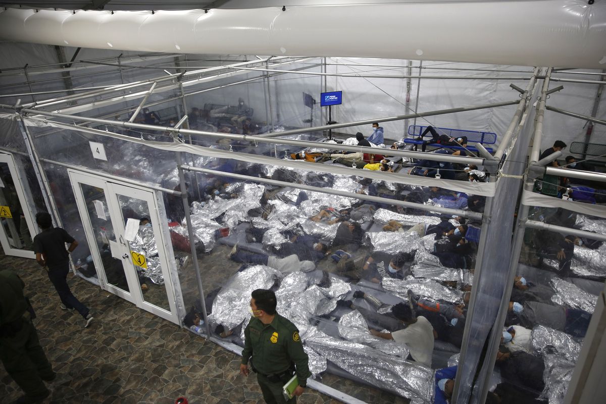 In this March 30, 2021, file photo, young minors lie inside a pod at the Donna Department of Homeland Security holding facility, the main detention center for unaccompanied children in the Rio Grande Valley run by U.S. Customs and Border Protection (CBP), in Donna, Texas. U.S. authorities say they picked up nearly 19,000 children traveling alone across the Mexican border in March. It