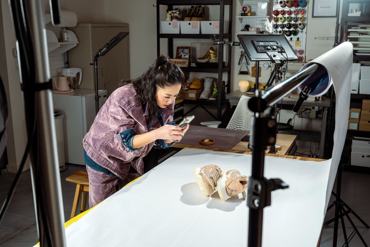 Ann Duskus photographs a pair of custom shoes at her office studio in San Francisco on Feb. 1.  (New York Times)