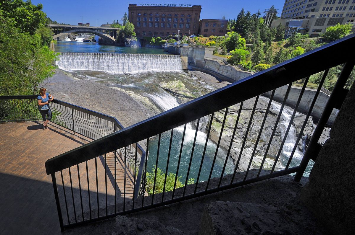 Kaye Turner, executive director of Friends of the Centennial Trail,  admires Spokane Falls at the Monroe Street Bridge on  July 2. (CHRISTOPHER ANDERSON / The Spokesman-Review)