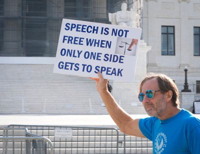 Protesters rally outside the Supreme Court as the justices hears oral arguments on whether Colorado's ban on providing conversion therapy to LGBTQ+ children violates a private therapist's rights to free speech in Washington, D.C., on Oct. 7, 2025.  (Jack Gruber/USA TODAY via Imagn)