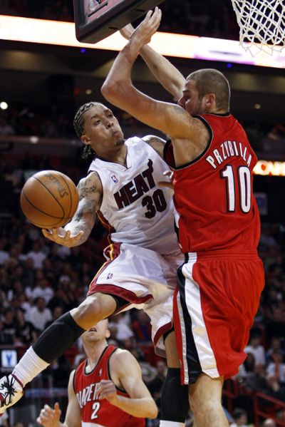 Portland Trail Blazers’ Joel Przybilla, right, blocks Michael Beasley as Beasley goes to the basket during the fourth quarter.  (Associated Press)