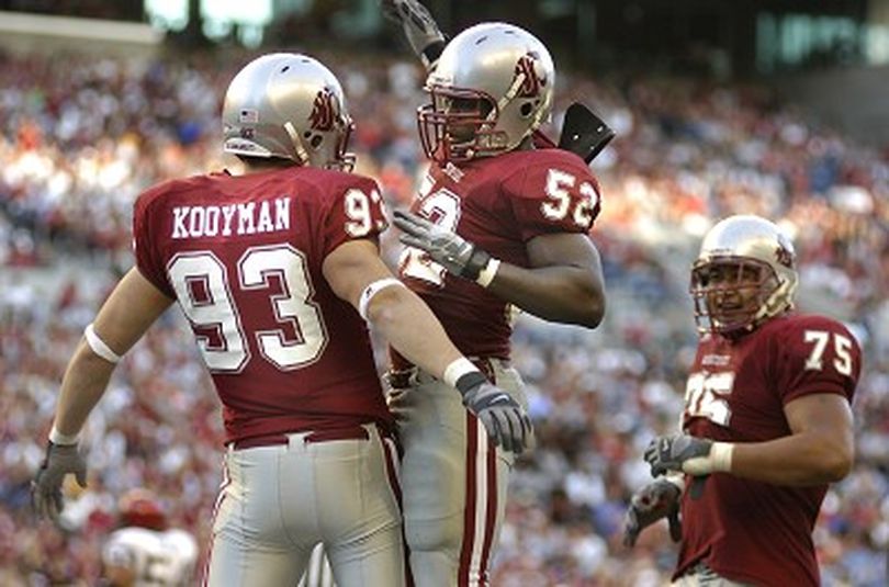 WSU defensive end Kevin Kooyman ( left) jumps and chest bumps with #52 Greg Trent after sacking San Diego State quarterback Kevin O'Connell for a 5 yard loss Saturday September 8, 2007 against San Diego State at QWest Field in Seattle.  CHRISTOPHER ANDERSON The Spokesman-Review (Christopher Anderson / The Spokesman-Review)