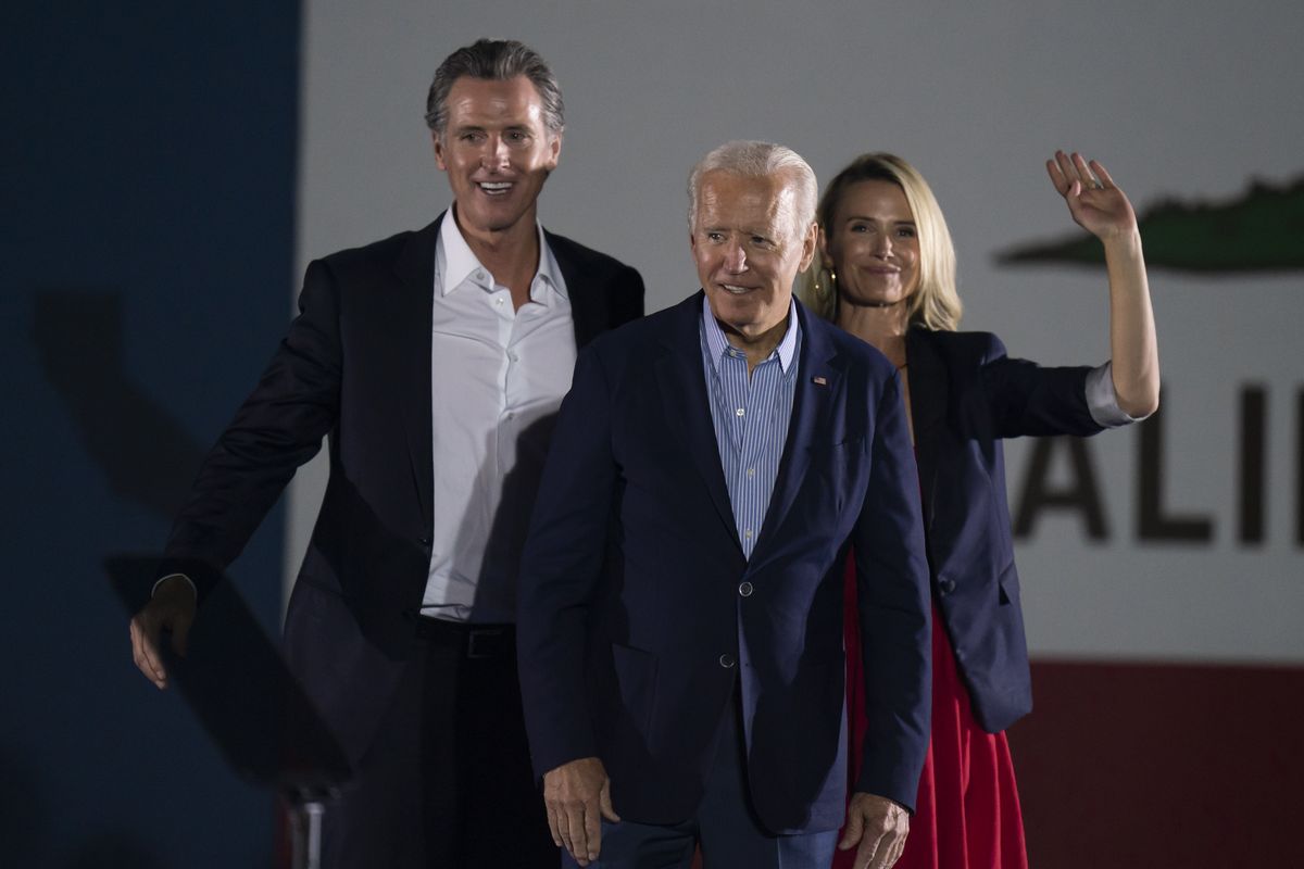 In this Sept. 13, 2021 photo, President Joe Biden, center, smiles to the crowd as he is flanked by California Gov. Gavin Newsom and Jennifer Siebel Newsom at a rally ahead of the California gubernatorial recall election in Long Beach, Calif. In the recall election, Newsom won big in coastal urban areas such as Los Angeles County, while the pro-recall side performed better in California