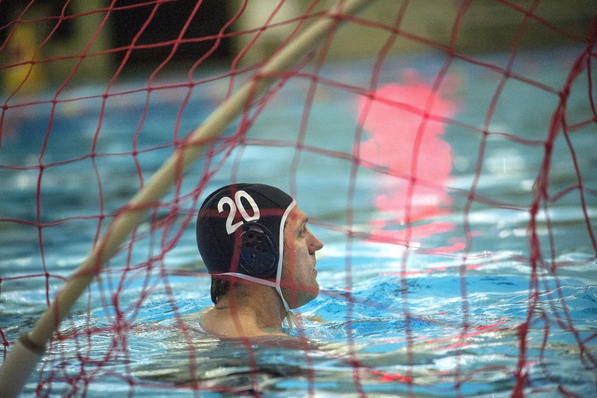 Water polo coach Peter Neirinckx waits for the drop of the ball while playing goalie during practice at the Kroc center in Coeur d’Alene on Jan. 25, 2016. (Kathy Plonka / The Spokesman-Review)