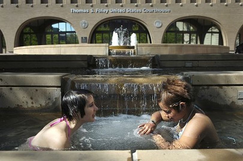 Andy Christensen (cq), left, 15, and Marche Osborne (cq), 14, cool off from 90-degree heat in the Thomas S. Foley federal courthouse fountain in downtown Spokane after school Wednesday afternoon, May 17, 2006.  More record-breaking temperatures are expected this week.  Holly Pickett The Spokesman-Review (Holly Pickett / The Spokesman-Review)