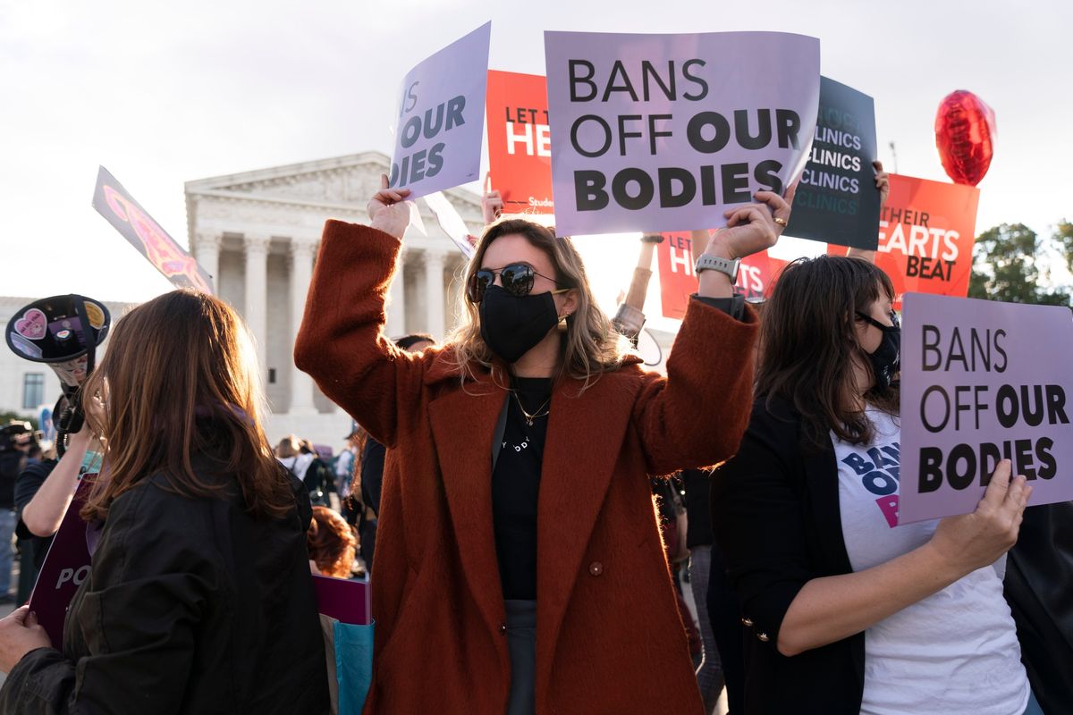 Emily Halvorson, center, with Planned Parenthood, joins groups of abortion-rights and anti-abortion activists on Nov. 1 as they rally outside the Supreme Court on Capitol Hill in Washington.  (Jacquelyn Martin)