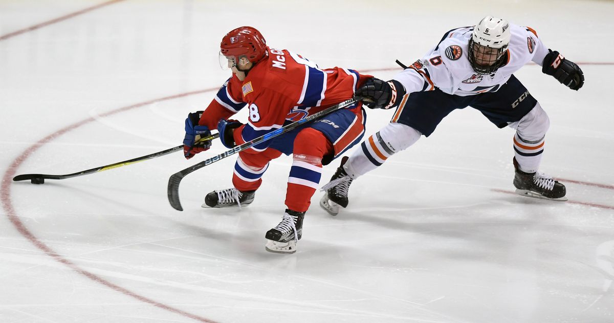 Spokane Chiefs right wing Jake McGrew (8) and Kamloops Blazers defenseman Sean Strange (6) compete for control of the puck during the second period of a WHL hockey game, Wed., Feb. 14, 2018, in the Spokane Arena. (Colin Mulvany / The Spokesman-Review)