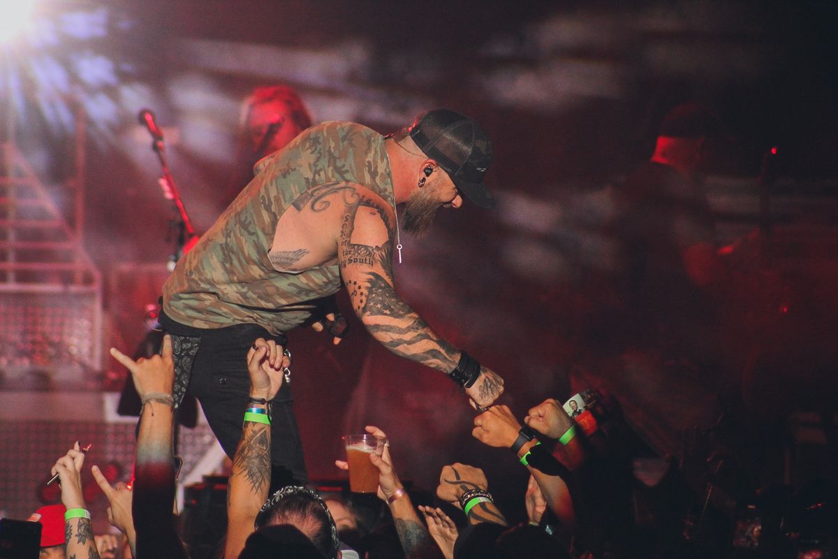 Brantley Gilbert fist-bumps a fan in the pit at Northern Quest Resort & Casino, Friday, Aug. 13, 2021. (Jordan Tolley-Turner/The Spokesman Review)
