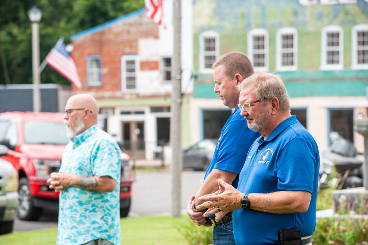 Community leader and minister Bobby Terry, Jarrod Sander and Centreville Mayor Mike Oakley lead a morning prayer gathering with members of the Centreville and Brent communities on July 26, in response to recent child abuse allegations. MUST CREDIT: Andi Rice/For The Washington Post  (Andi Rice/For The Washington Post)