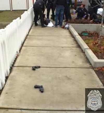 Two tasers lie on the sidewalk at the scene where a suspect was taken into custody Sunday. (Spokane Police Department)