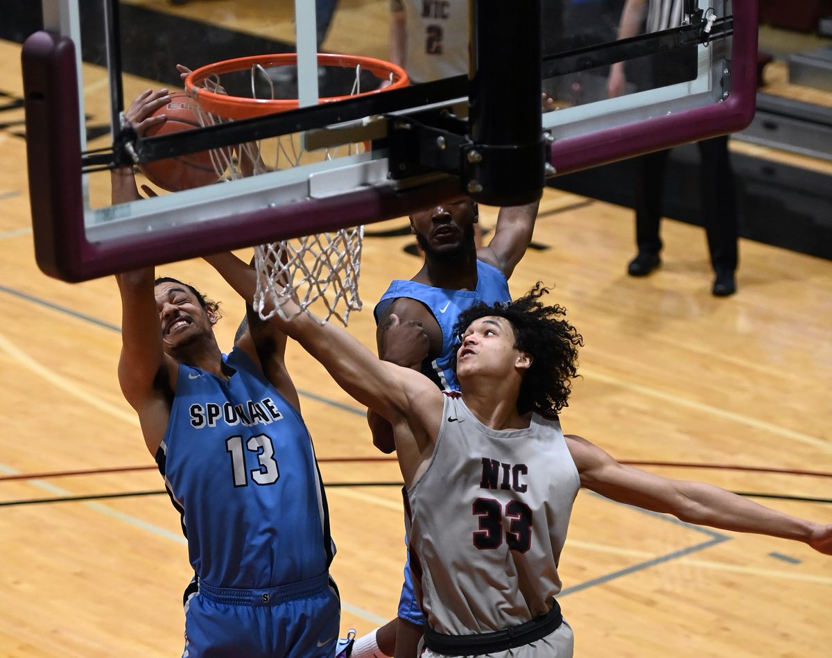 Community Colleges of Spokane center Kobe Reese grabs a rebound away from North Idaho College forward Akeyse Rice during their game last April at NIC.  (Colin Mulvany/THE SPOKESMAN-REVIEW)