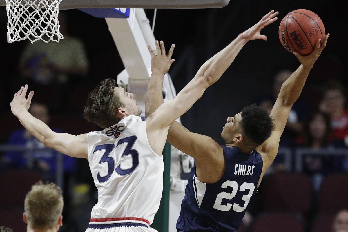 BYU forward Yoeli Childs attempts a shot against Saint Mary’s Kyle Clark in the WCC Tournament last March. (John Locher / Associated Press)