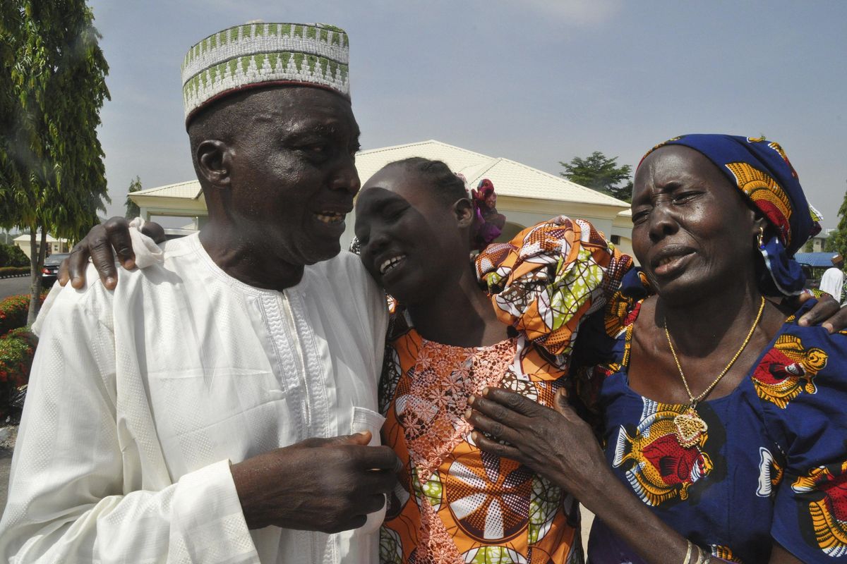 Family members celebrate as they embrace a relative, one of the released kidnapped schoolgirls, in Abuja, Nigeria, Saturday, May 20, 2017. The 82 Nigerian schoolgirls recently released after more than three years in Boko Haram captivity reunited with their families for the first time Saturday, as anxious parents looked for signs of how deeply the extremists had changed their daughters’ lives. (Olamikan Gbemiga / Associated Press)
