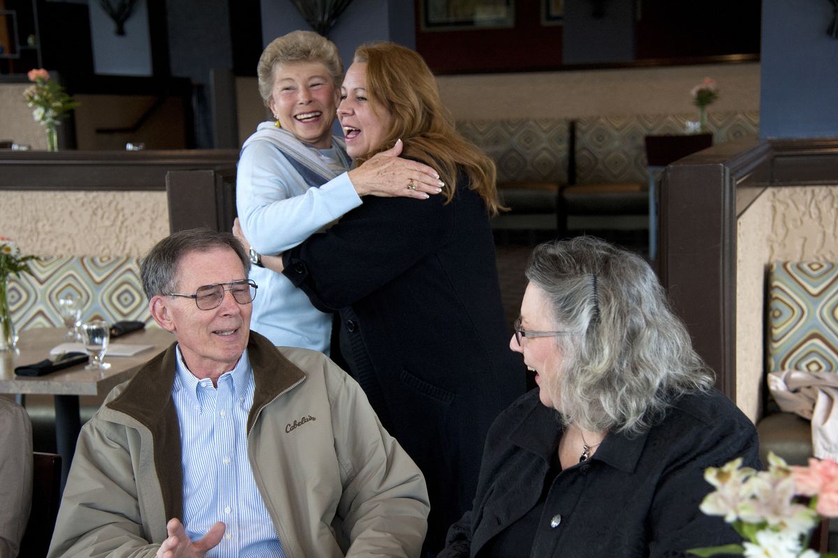 Pat Donais, top left, greets Sandy Crosby as Dr. Herbert Mueller, front left, visits with Diane Rowse during a luncheon gathering at the Red Lion Hotel at the Park for former dentists and employees of the Hillyard Dental Clinic on March 14, 2014. Donais worked at the front desk, Crosby was a dental assistant, Rowse, a hygienist and Mueller, a dentist. (Dan Pelle)