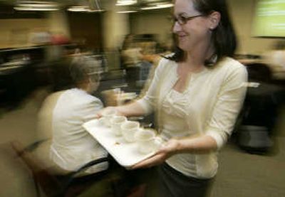 
Bridget Baker, who works in media relations for Starbucks Corp., whisks a tray bearing samples of the company's new line of 